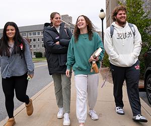 Image of Jackie Piddock walking with friends on campus.